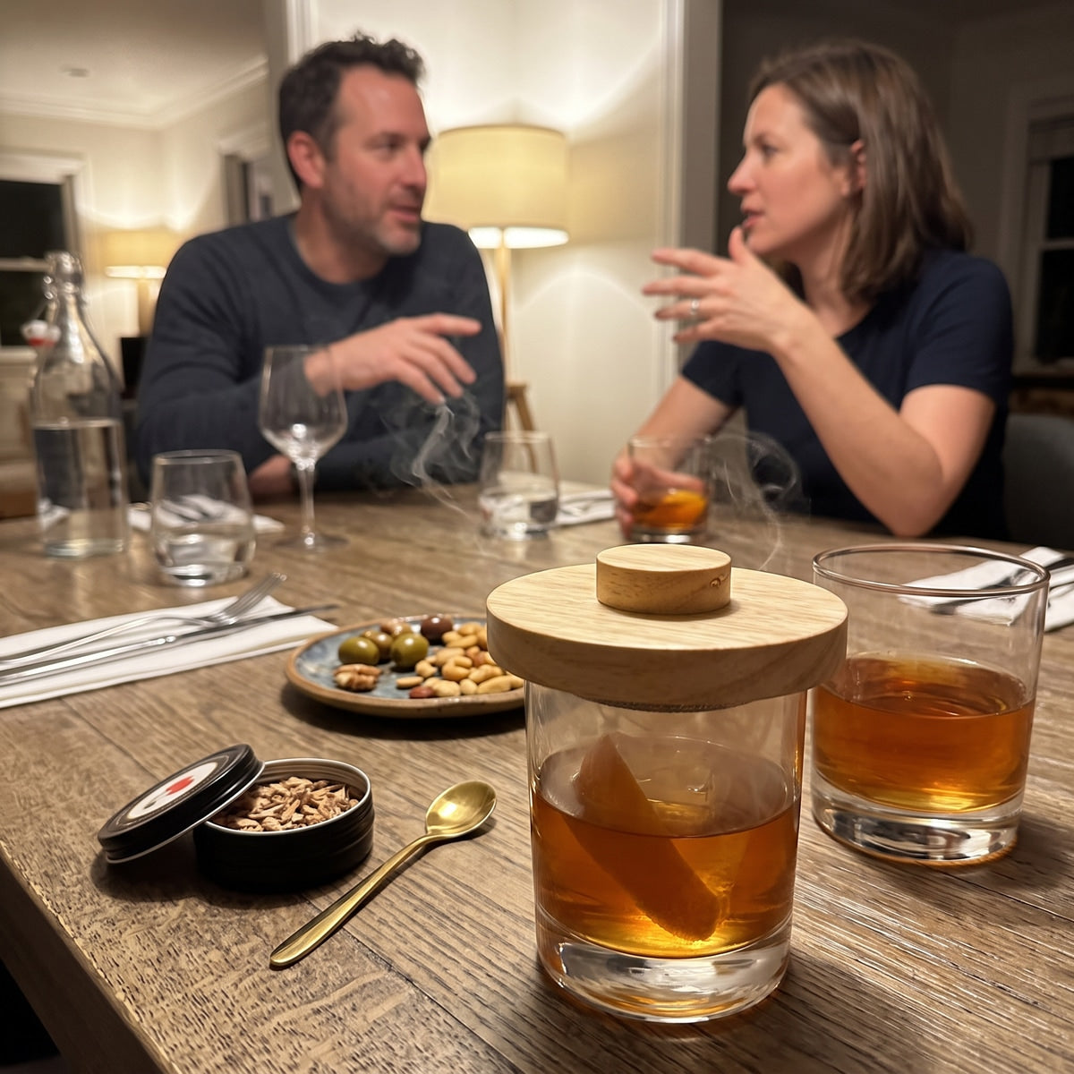 Two adults and cocktails at a dinner table