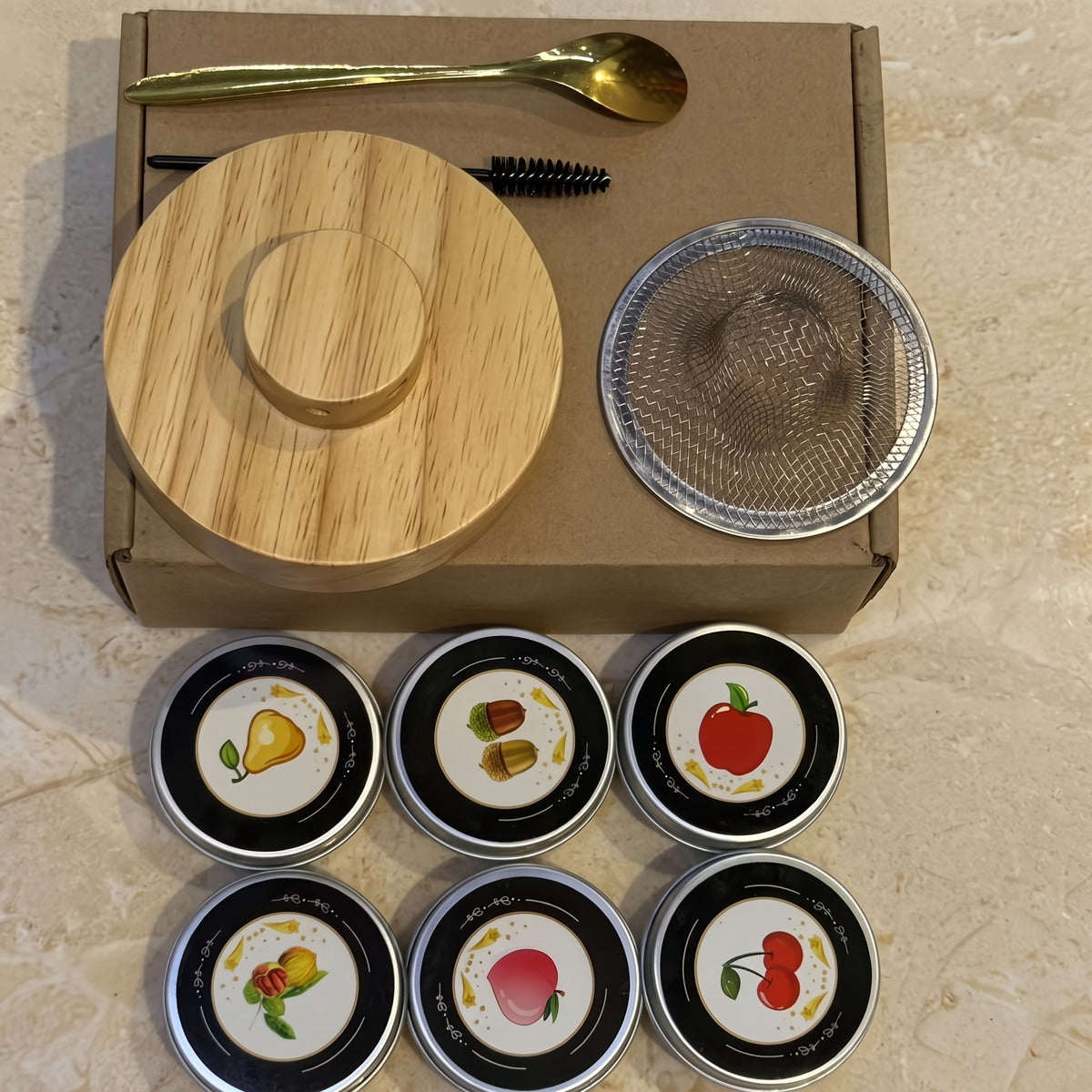Smoker kit and six tins beside the brown carton