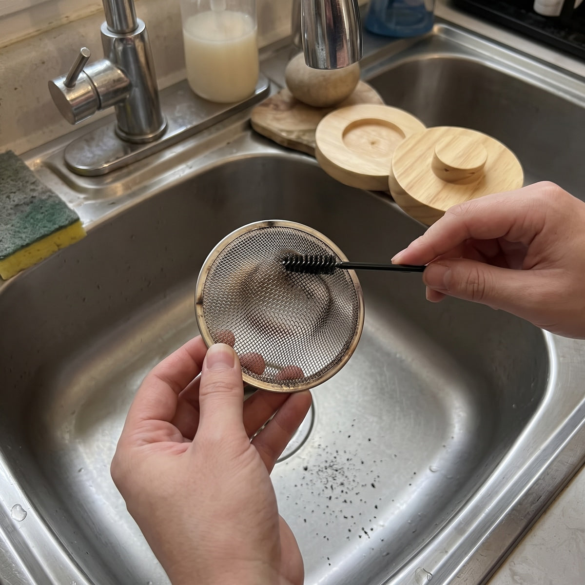 Brush cleaning the cooled metal mesh