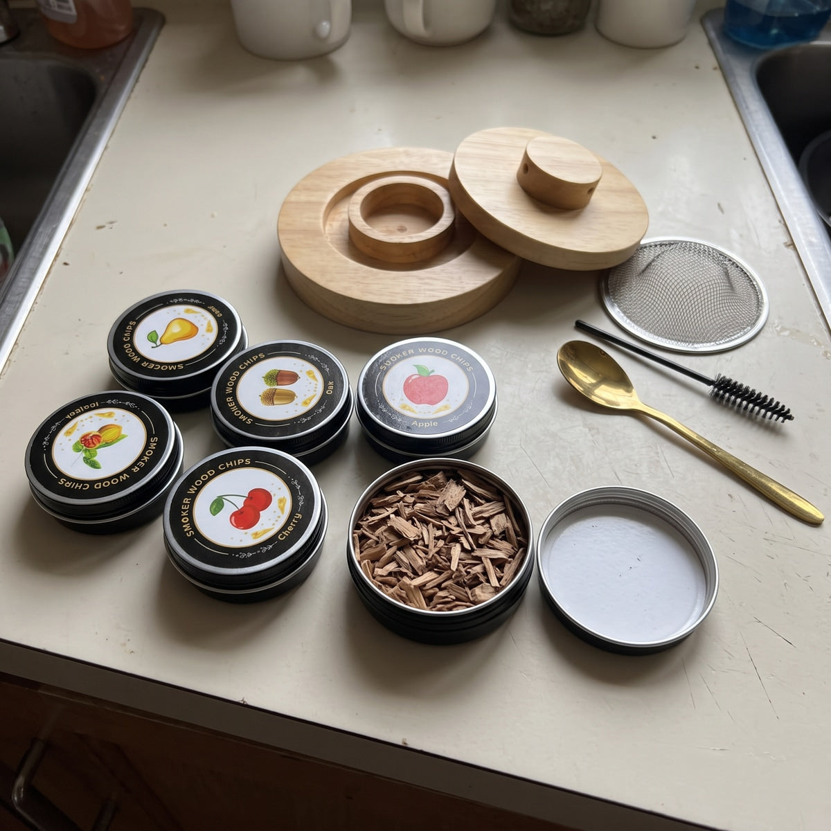 Six tins with one open beside a spoon